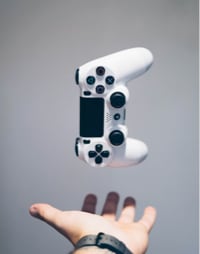 a hand reaching for a gaming control