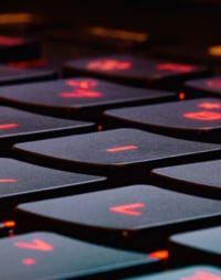 a black laptop keyboard with bright red accents on the keys